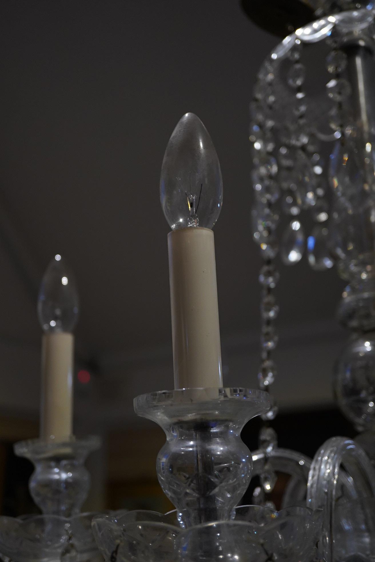 A cut glass five branch chandelier with drops